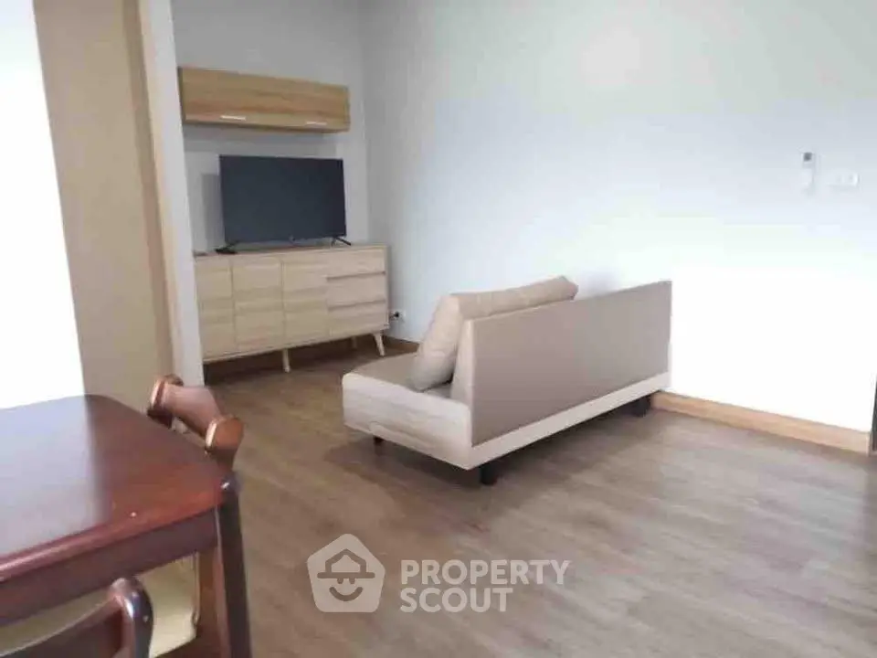 Spacious living room with modern furniture and wooden flooring