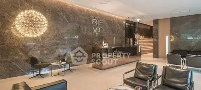 Luxurious modern lobby with elegant seating and stunning lighting in a high-end building.