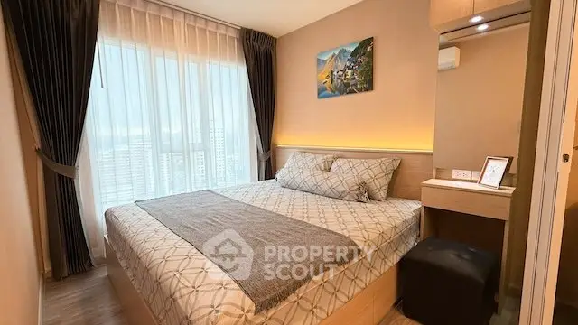 Cozy bedroom with modern decor and large window offering city views.