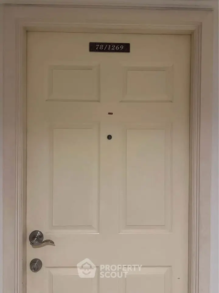 Elegant apartment entrance door with modern handle and peephole