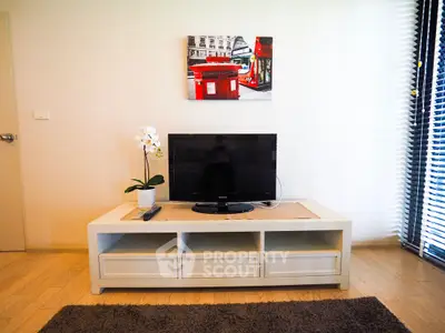 Modern living room with sleek TV stand and vibrant wall art, perfect for urban living.