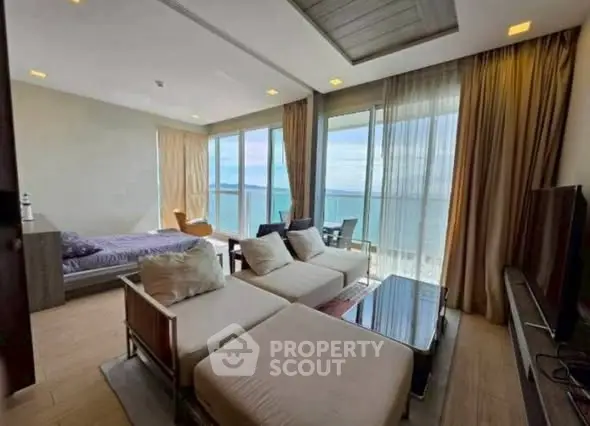 Luxurious beachfront living room with stunning ocean view and modern furnishings.