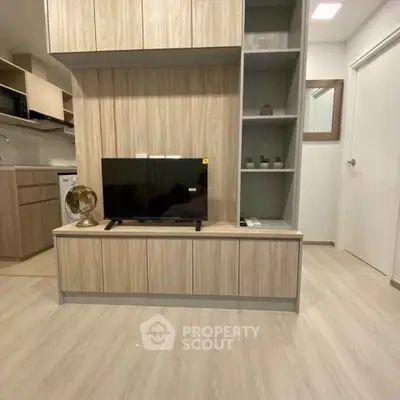 Modern living room with sleek wooden cabinetry and flat-screen TV, perfect for contemporary urban living.
