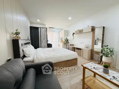 Modern studio apartment with cozy bed, stylish furniture, and open layout