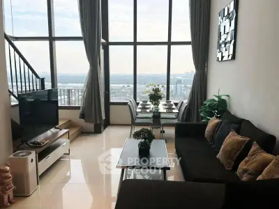 Luxurious high-rise living room with panoramic city views and elegant decor.