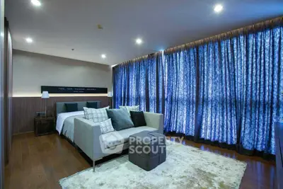 Spacious modern bedroom with elegant decor and large windows