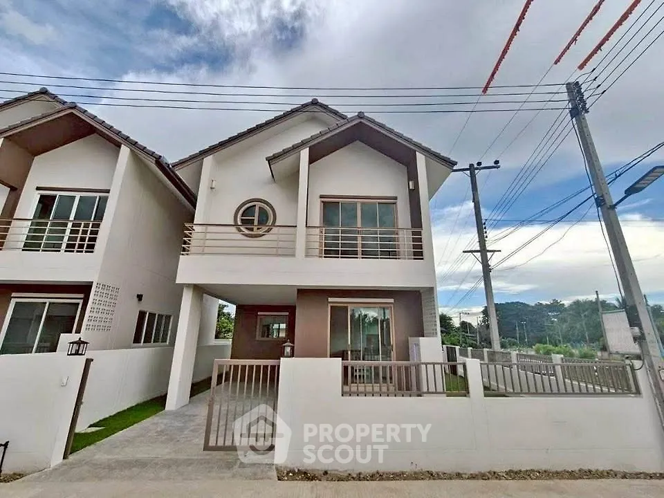 Modern two-story house with spacious balcony and gated entrance