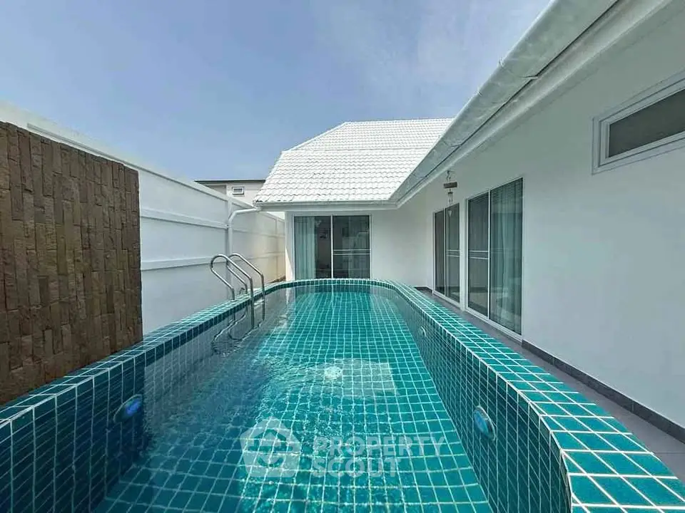 Luxurious private villa with stunning turquoise pool and modern architecture.