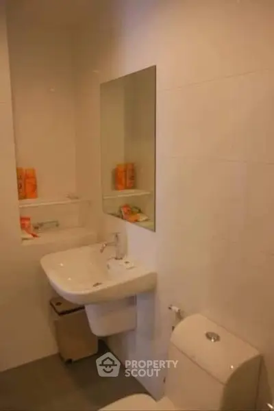 Modern bathroom with sleek sink and mirror, ideal for compact spaces.