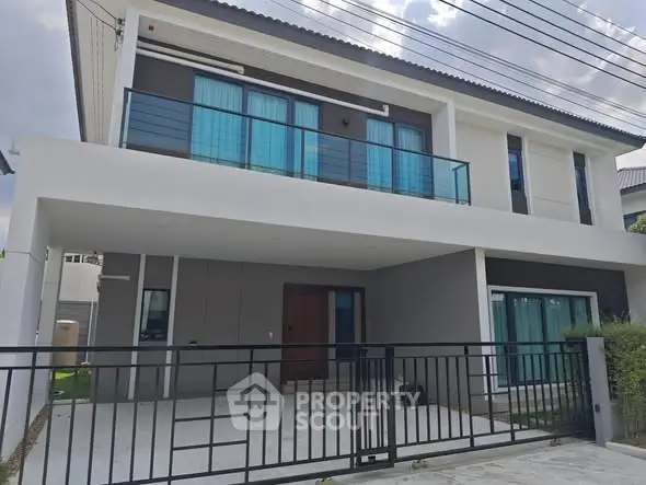 Modern two-story house with sleek design and spacious balcony, perfect for family living.