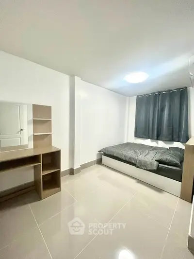 Modern minimalist bedroom with sleek furniture and natural light