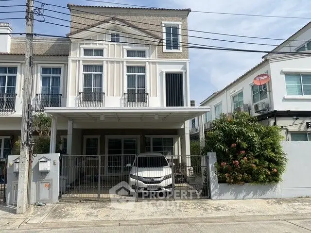 Modern townhouse with carport and gated entrance in a suburban neighborhood.
