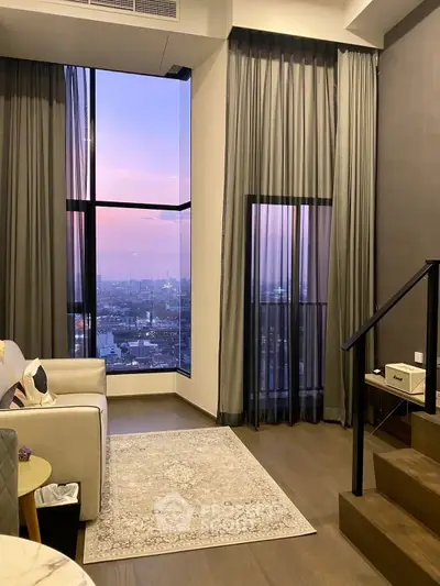 Luxurious living room with stunning city view and elegant decor at sunset
