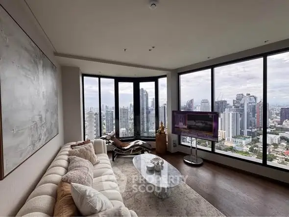 Luxurious high-rise living room with panoramic city views and modern decor.