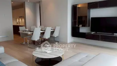 Modern living room with sleek furniture and open dining area