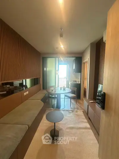 Modern living room with stylish decor and open layout, featuring a cozy seating area and natural light.