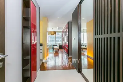 Modern apartment entrance with stylish red accents and open living area
