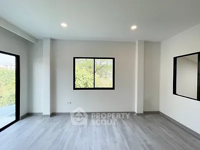 Spacious modern room with large windows and sleek flooring