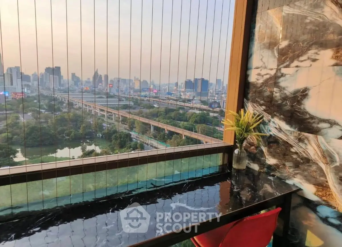 Stunning cityscape view from a luxurious high-rise balcony with elegant marble decor.