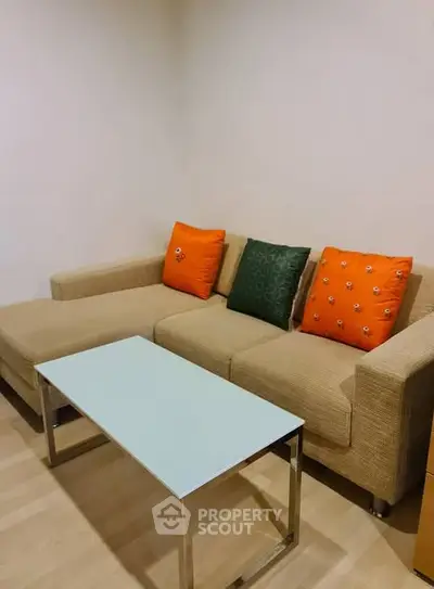 Cozy living room with modern beige sofa and colorful cushions