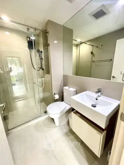 Modern bathroom with glass shower and sleek fixtures