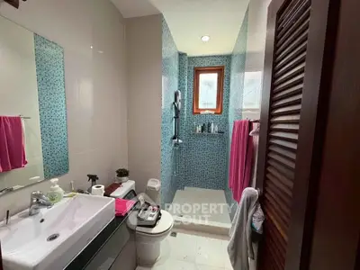 Modern bathroom with walk-in shower and stylish blue mosaic tiles