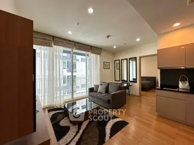 Modern living room with open layout, stylish decor, and natural light in a contemporary apartment.