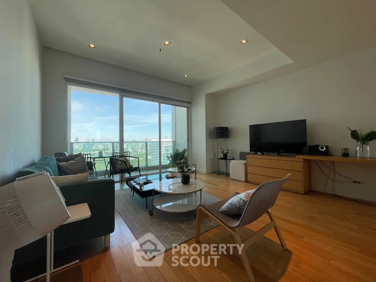 Spacious living room with modern decor and stunning city view from large windows.