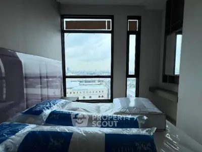 Modern bedroom with large window offering stunning city view