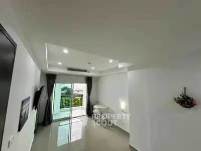 Spacious modern living room with balcony access and sleek design