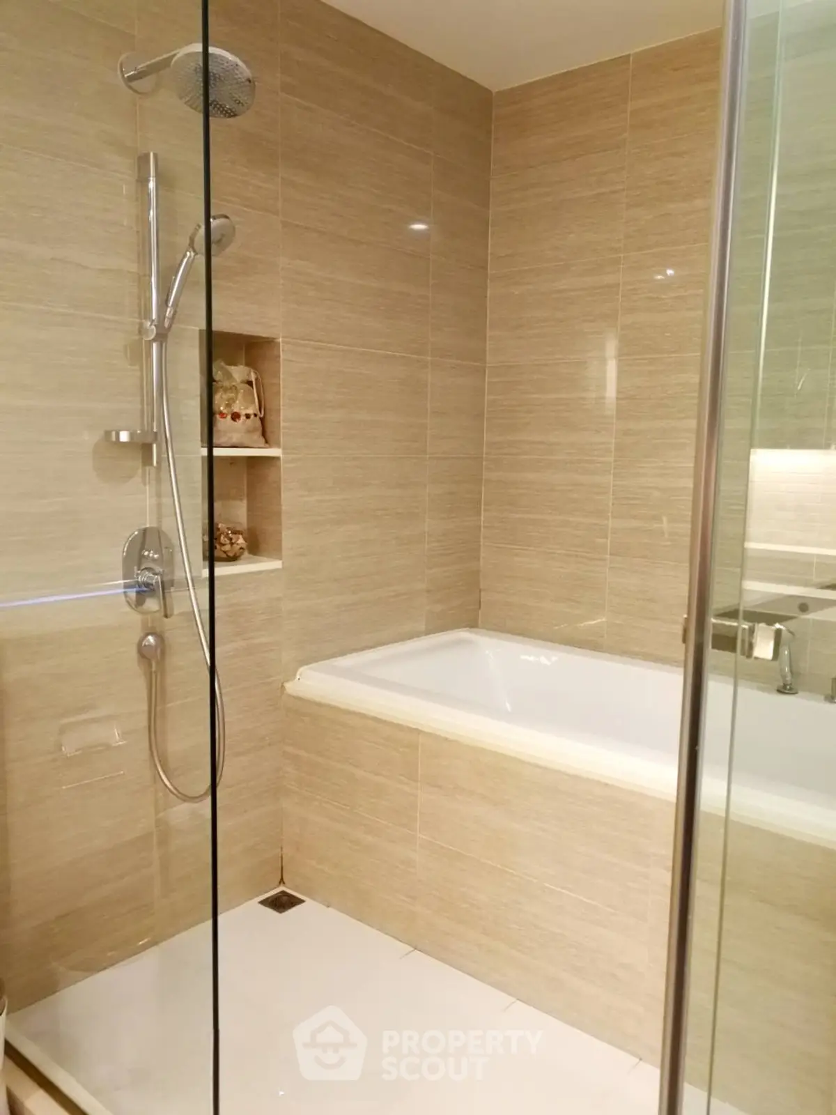 Modern bathroom with elegant beige tiles and built-in bathtub