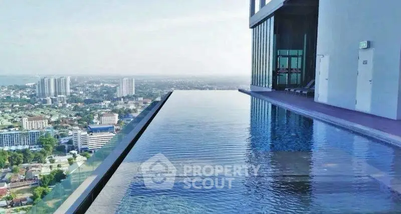 Stunning rooftop infinity pool with panoramic city views in luxury high-rise building.