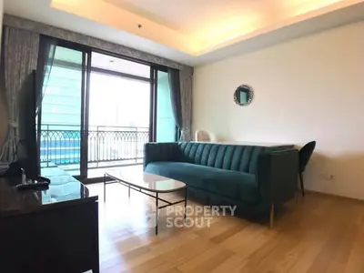 Spacious living room with elegant sofa and large balcony access