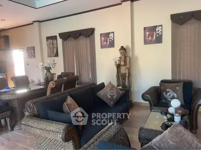 Charming living room with wicker furniture and Asian decor, perfect for relaxation and entertaining guests.