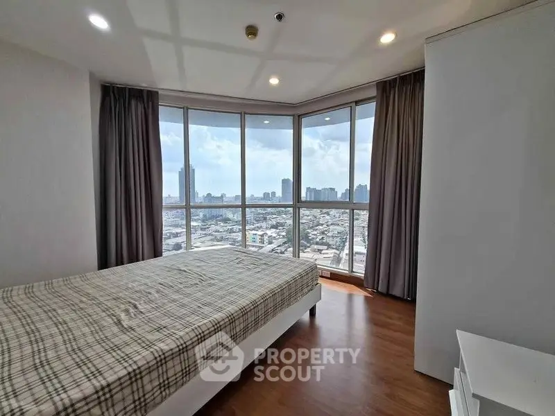 Spacious bedroom with panoramic city view and modern decor