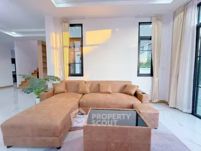 Spacious modern living room with large sectional sofa and natural light