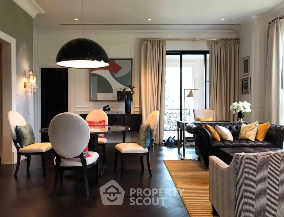 Luxurious living room with elegant decor and spacious seating area, featuring modern lighting and stylish furnishings.