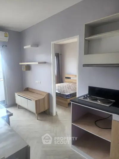 Modern apartment interior with open kitchen and cozy bedroom view