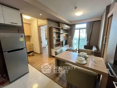 Modern open-plan kitchen and living room with stylish decor and natural light.