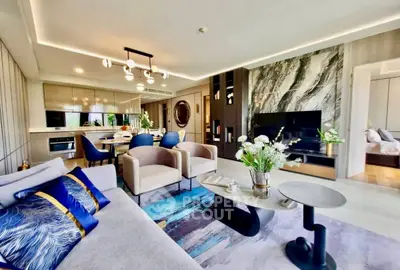 Luxurious modern living room with elegant decor and open layout, featuring stylish furniture and a stunning marble accent wall.