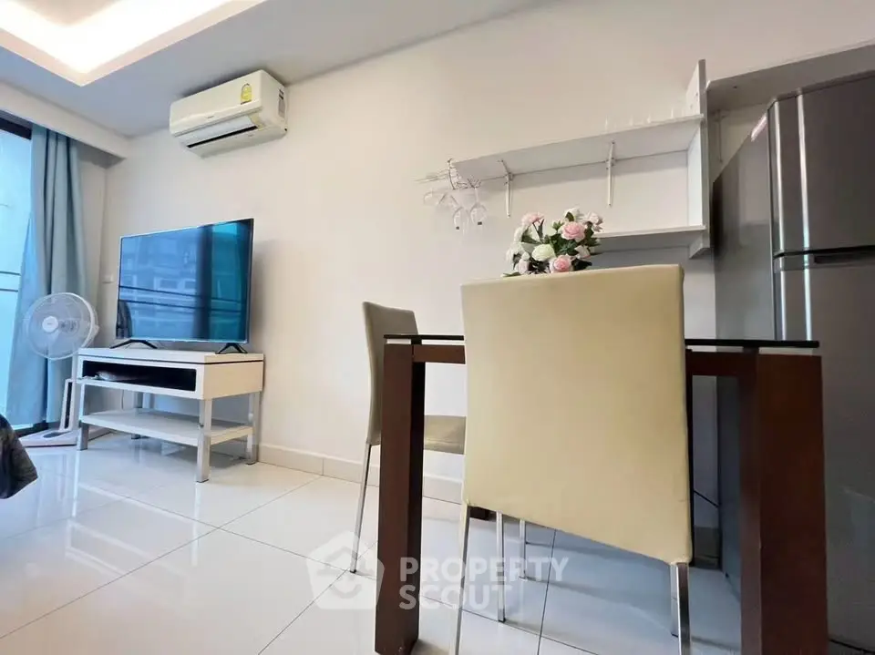 Modern living room with dining area, featuring sleek furniture and contemporary decor.