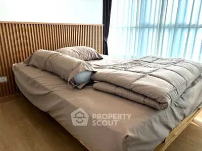Modern bedroom with stylish wooden headboard and cozy bedding