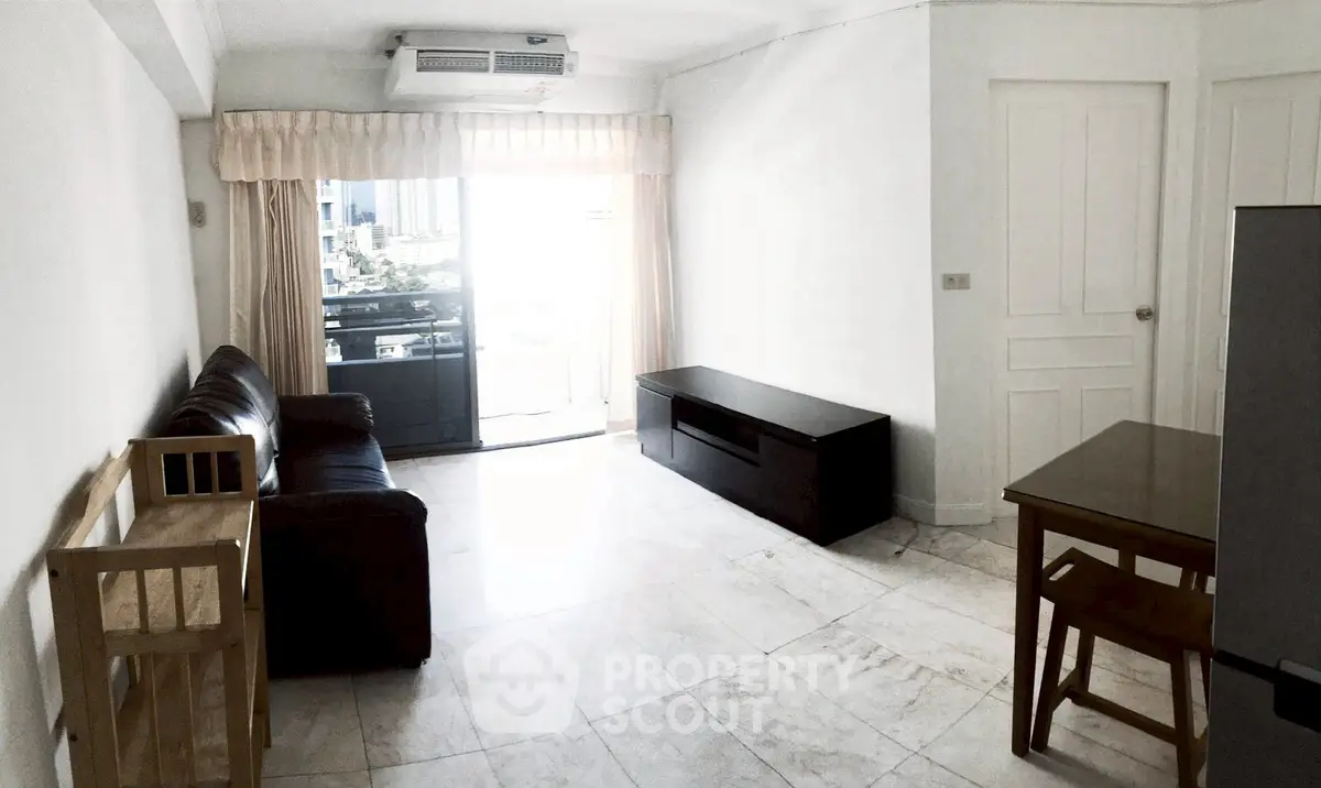 Spacious living room with modern furniture and city view balcony