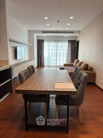 Spacious modern living room with elegant dining area and large windows.