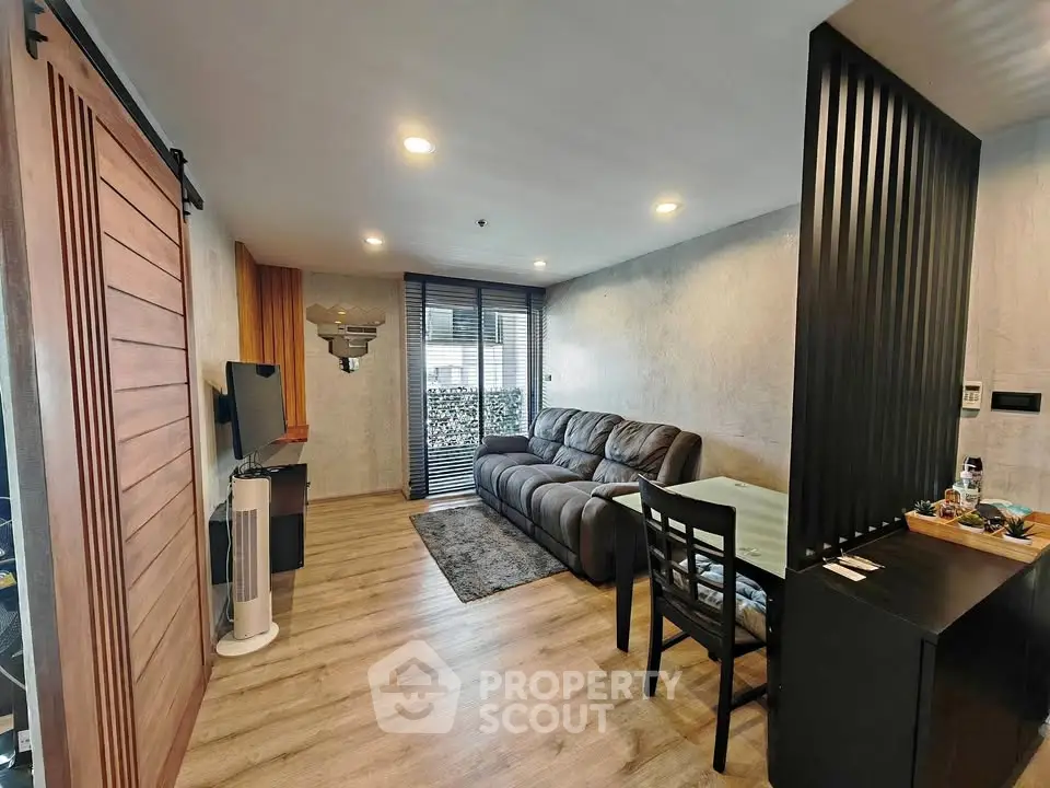 Modern living room with cozy sofa and stylish decor in a contemporary apartment.