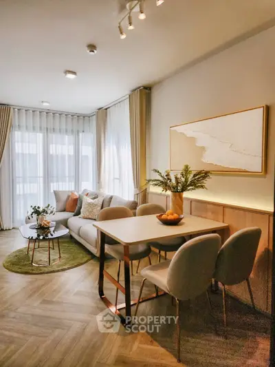 Stylish living room with modern decor and natural light, featuring a cozy seating area and elegant dining space.