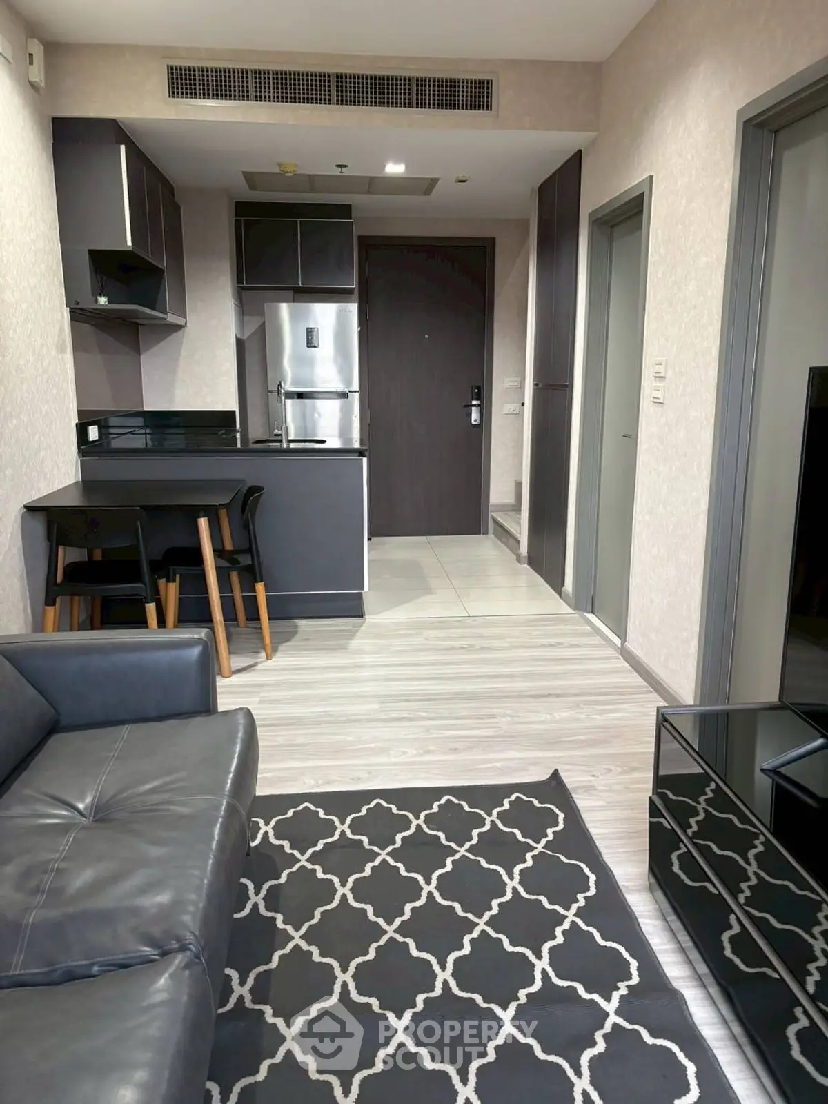 Modern open-plan living room with sleek kitchen and stylish decor