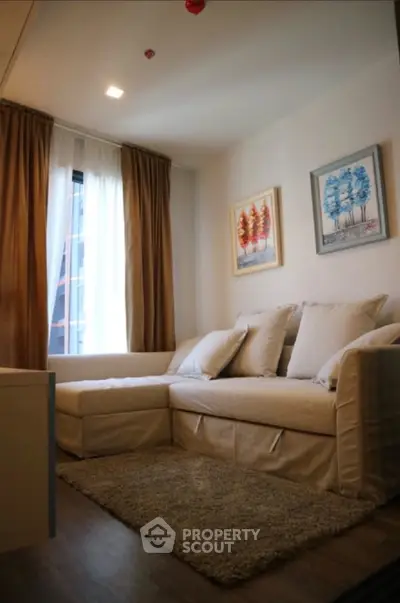 Cozy living room with stylish decor and comfortable seating in modern apartment.