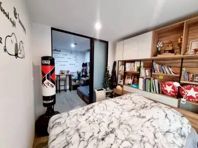 Cozy bedroom with stylish decor and built-in bookshelf
