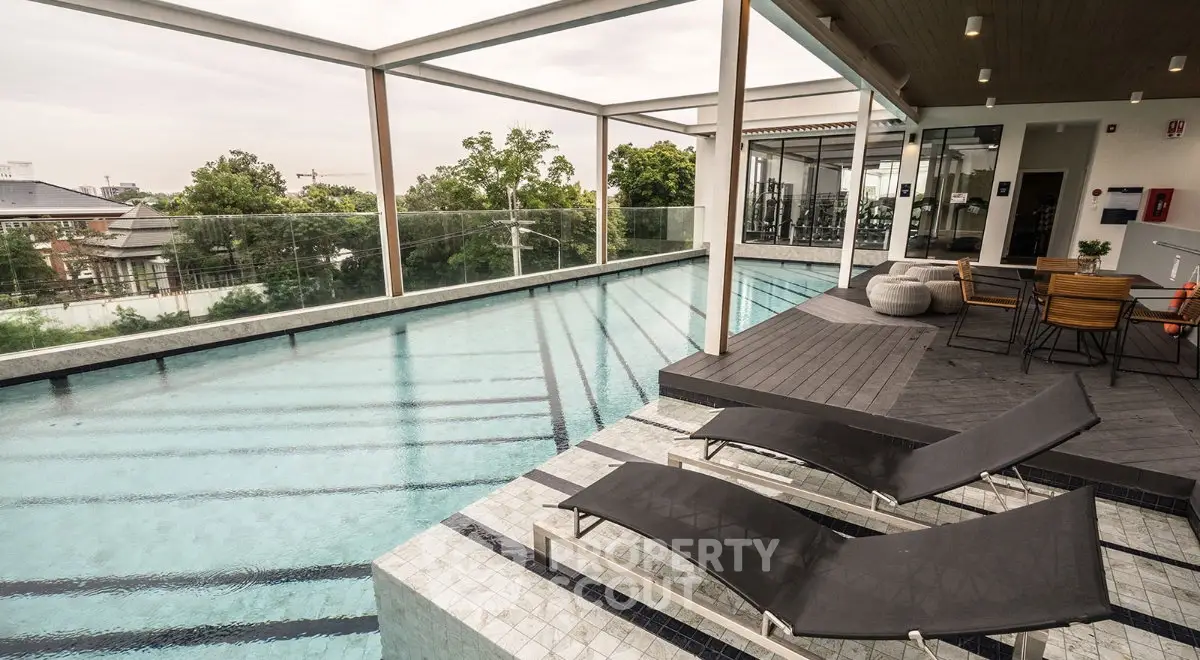 Luxurious rooftop pool with modern lounge area and stunning city views.